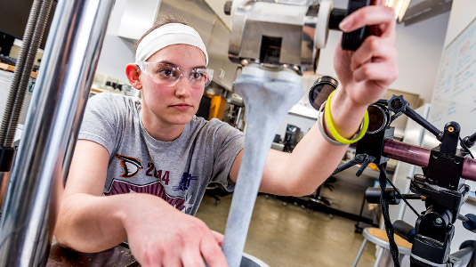 Student tests joint replacement device.